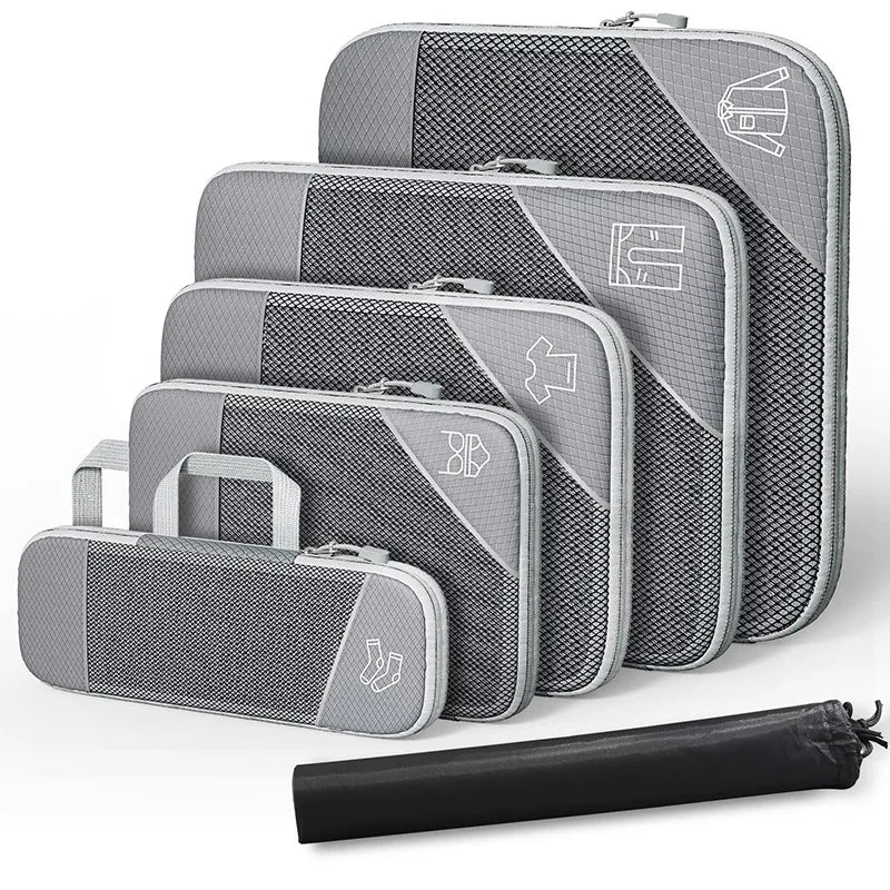 Set of gray packing cubes with a black compression bag on a white background