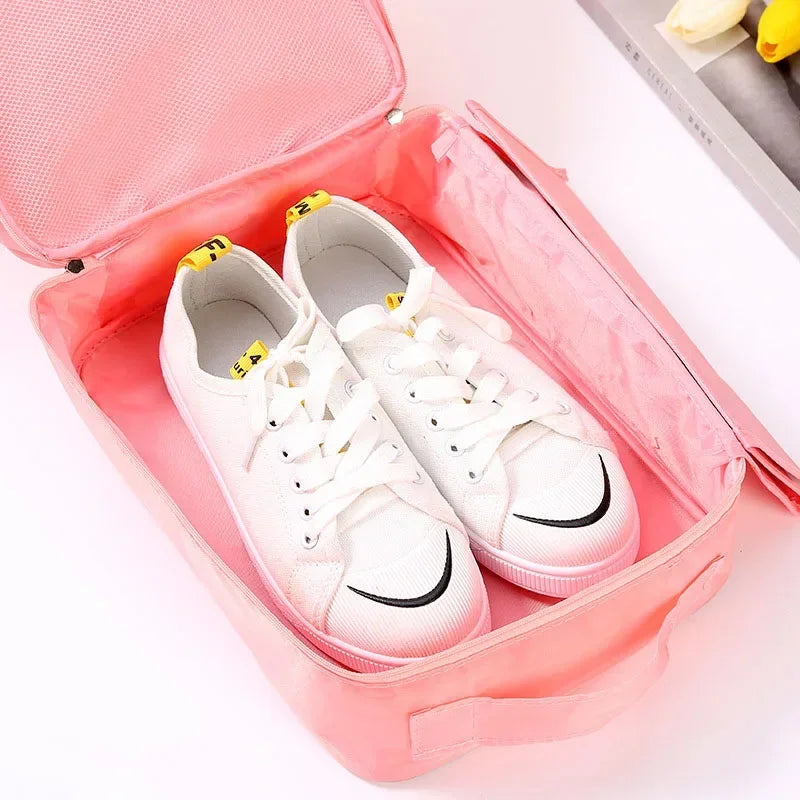 White sneakers with black swooshes in a pink shoe organizer