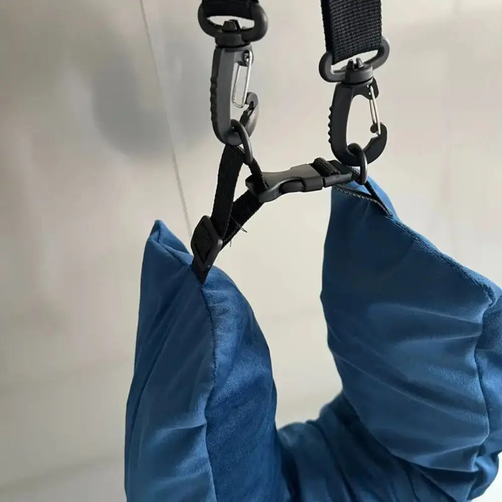 Blue bag with black straps and carabiner on a light gray background