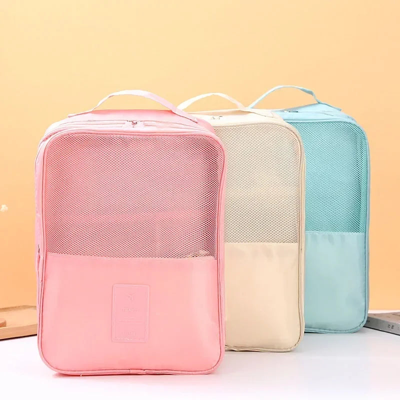 Three mesh storage bags in pink, beige, and blue on a white surface with a yellow background.