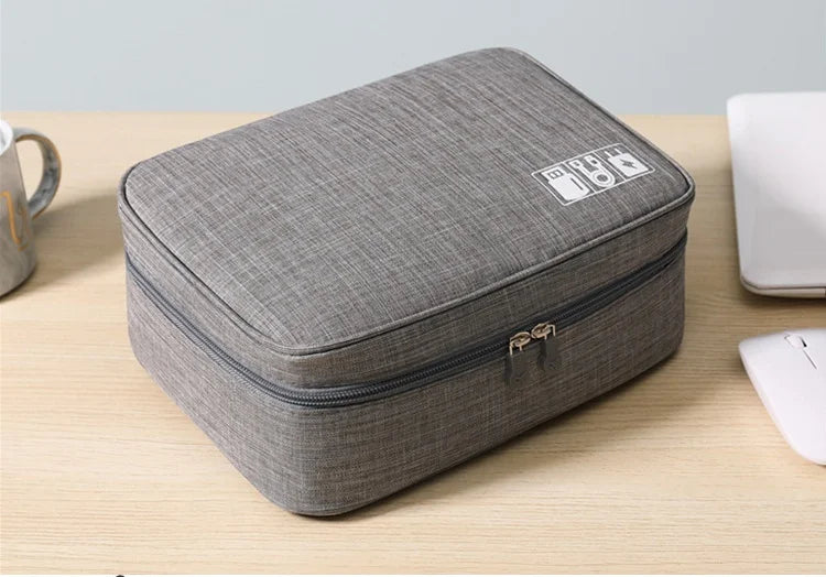 Gray travel case on a wooden surface with a light gray background