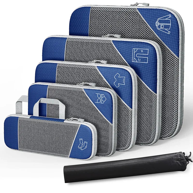 Set of blue and gray packing cubes with a black rolling garment bag on a white background
