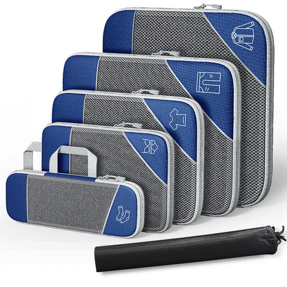 Set of blue and gray packing cubes with a black rolling garment bag on a white background