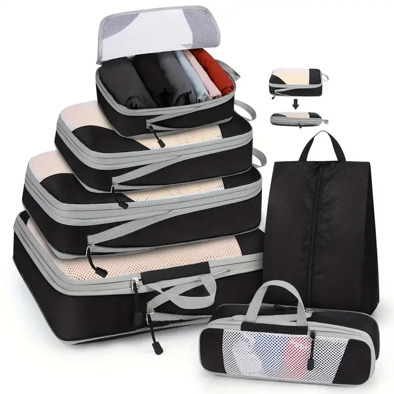 Set of black and gray packing cubes with a black travel bag on a white background