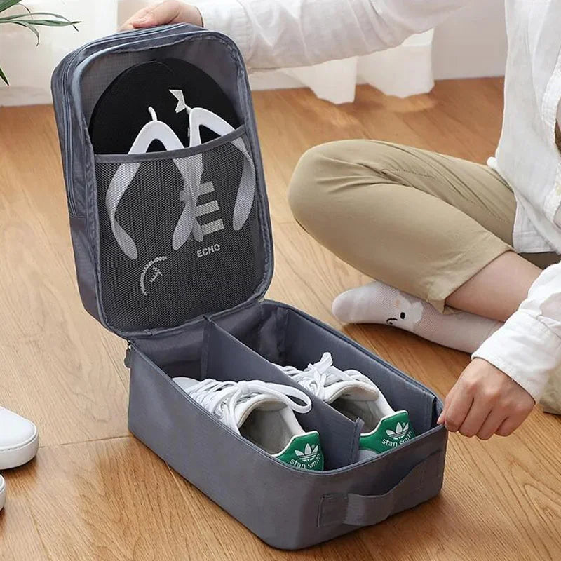 Person organizing white sneakers into a gray shoe organizer on a wooden floor.