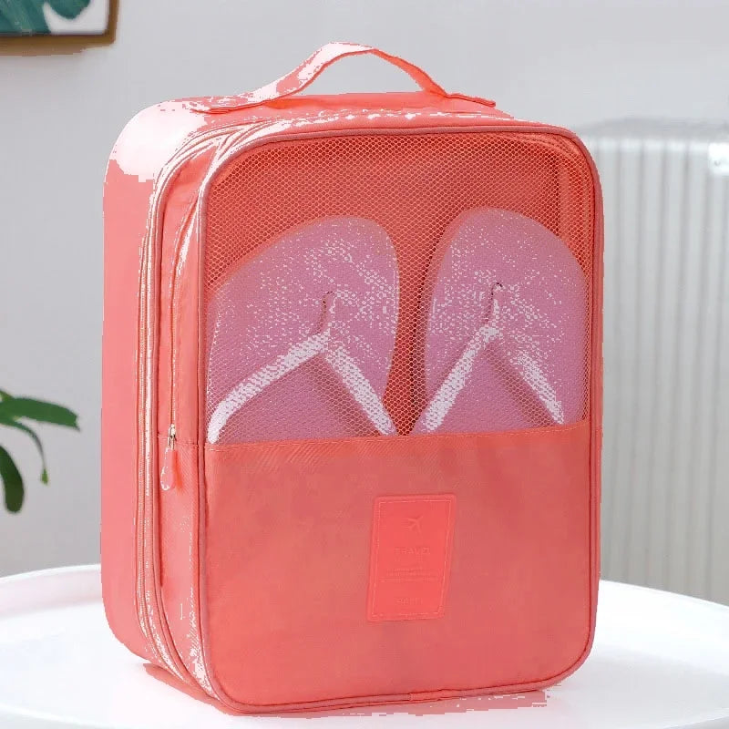 Coral-colored shoe packaging bag with a clear section revealing pink flip-flops on a white surface.
