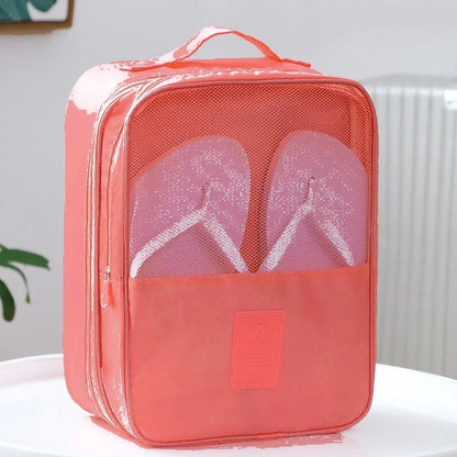 Coral-colored shoe packaging bag with a clear section revealing pink flip-flops on a white surface.