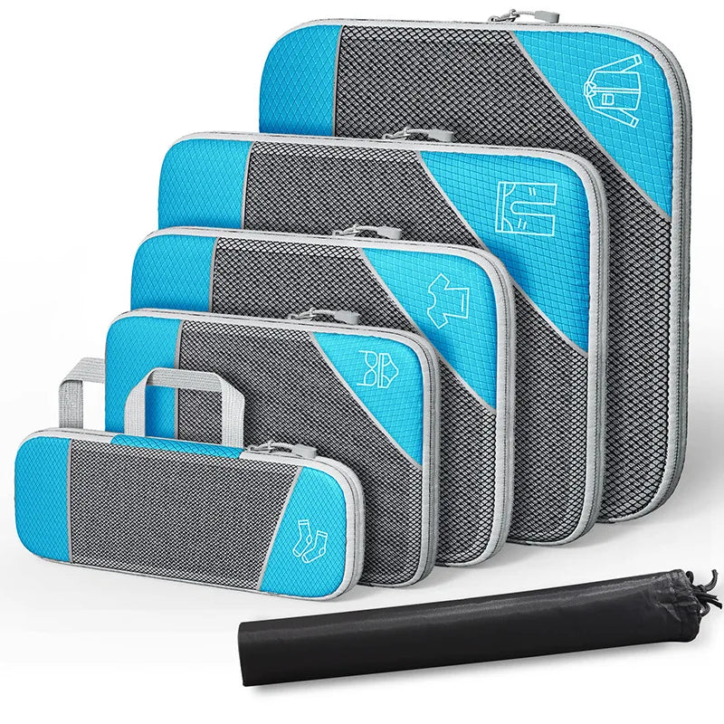 Set of blue and gray packing cubes with a black rolling bag on a white background