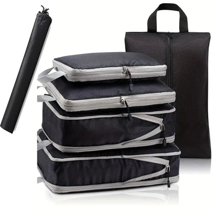 Set of black and gray packing cubes with a travel mat on a white background