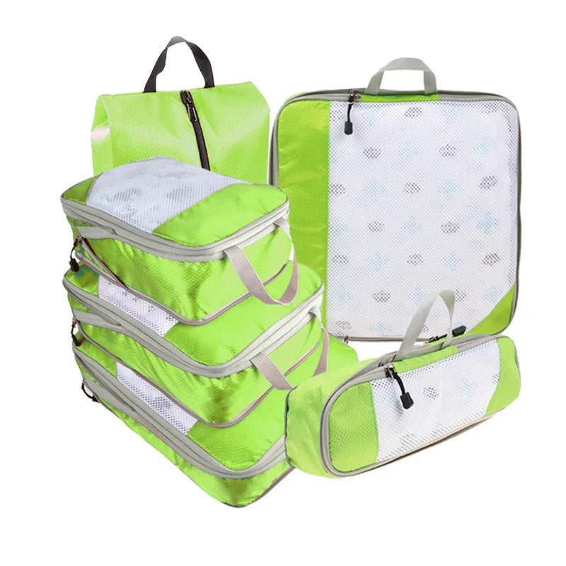 Set of green packing cubes with mesh compartments on a white background