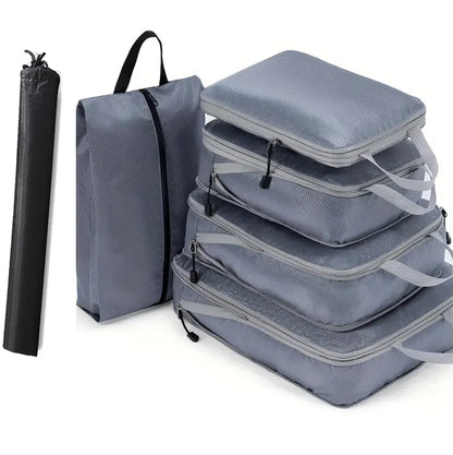 Set of gray packing cubes with a black rolling mat on a white background